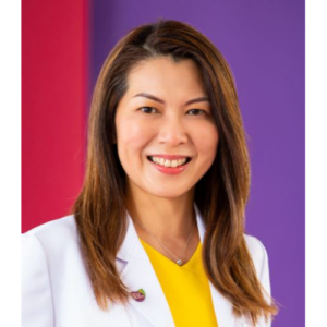 Cheerful image of Siew smiling in front of a red and purple background