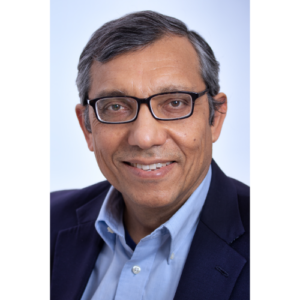 Professor Zulfiqar headshot wearing a suit in front of a light blue background