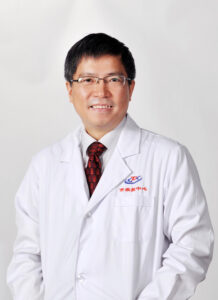 Dr Quanyi Wang standing smiling at the camera