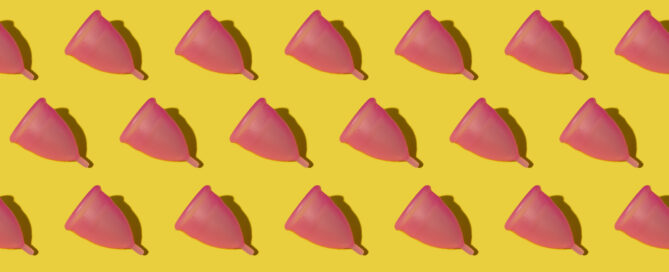Pattern of rows of pink menstrual cups