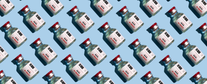 Repeated vials with covid-19 vaccine on the blue background
