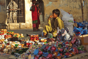 Street child selling cups