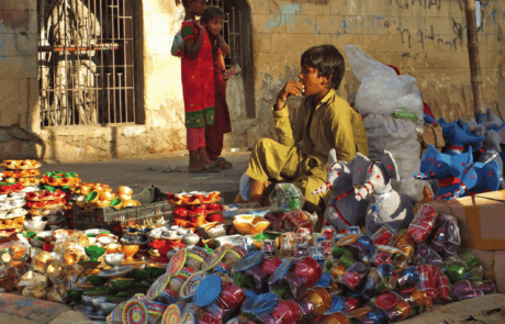 Street child selling cups