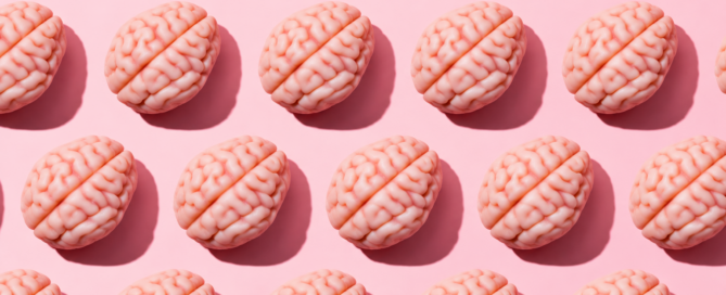 Pattern of small pink model brains arranged in rows on a pale pink background.